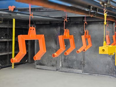 Parts being powder coated orange